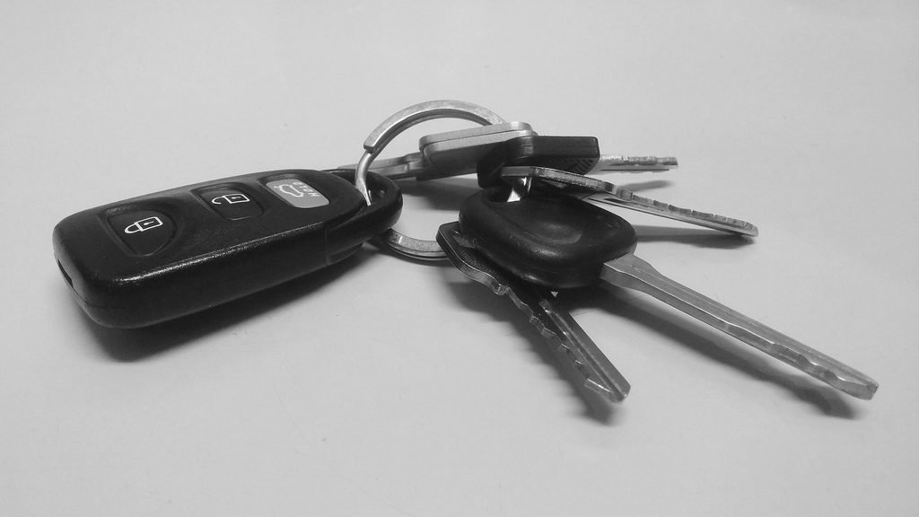 Car key fob resting near a vehicle's ignition switch