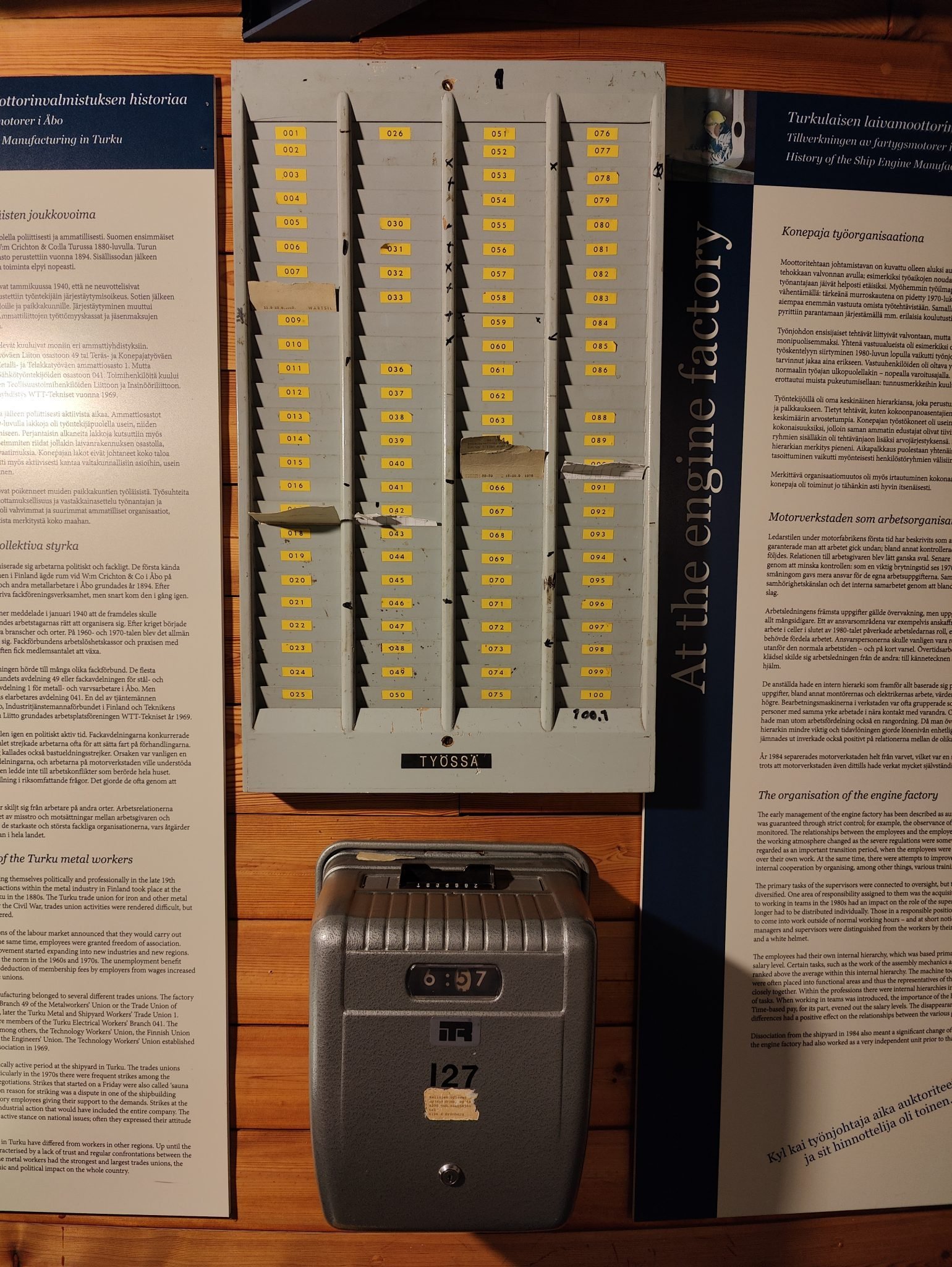 Old-fashioned punch clock with in/out time card slots used to track employee work hours