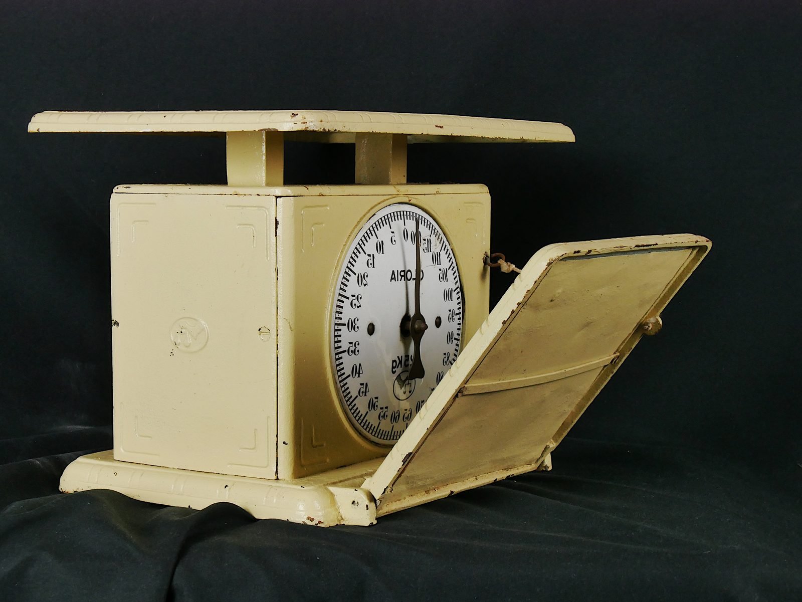 Analog bathroom scale with a round mirrored dial, used to track body weight